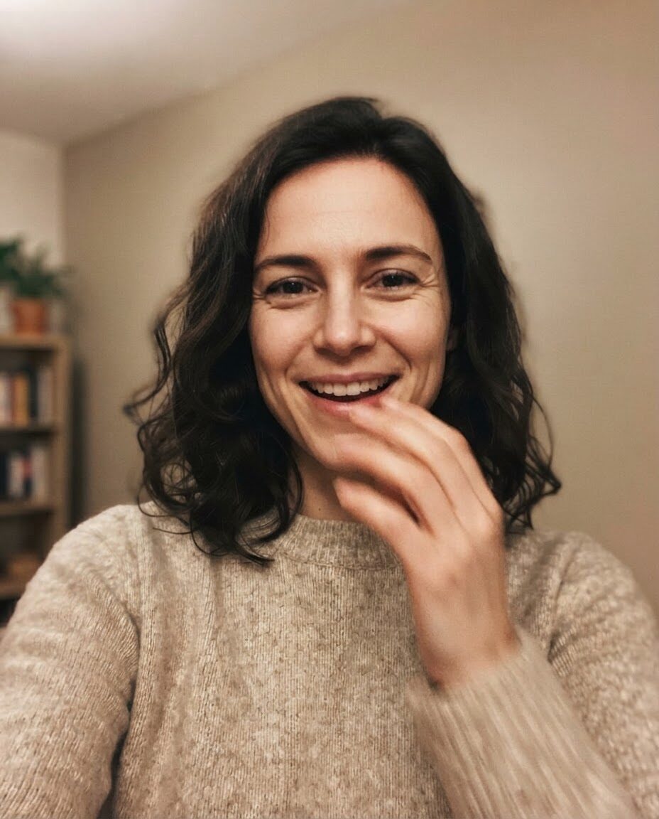 Alex's reaction: a surprised, delighted laugh, one hand near her mouth